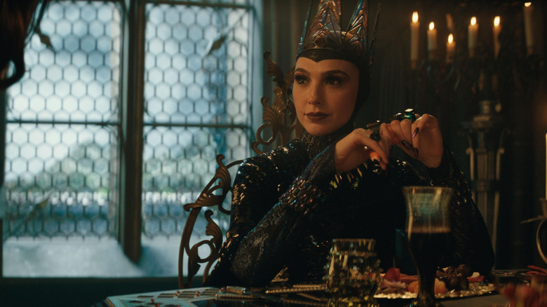 The Evil Queen sternly eating dinner