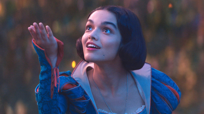 Snow White in her traditional blue outfit with her hand outstretched in Snow White