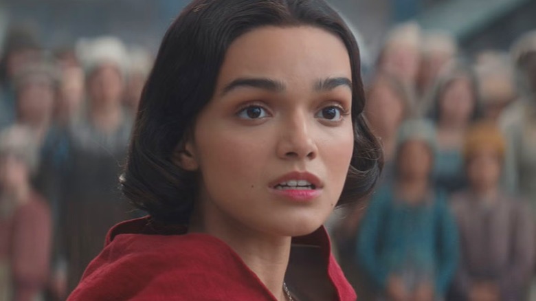 Snow White looking shocked wearing a red cape in Snow White