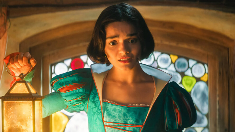 Snow White holding a lantern and looking concerned in Snow White