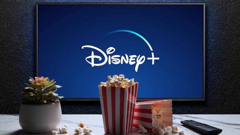 Popcorn near TV playing Disney+