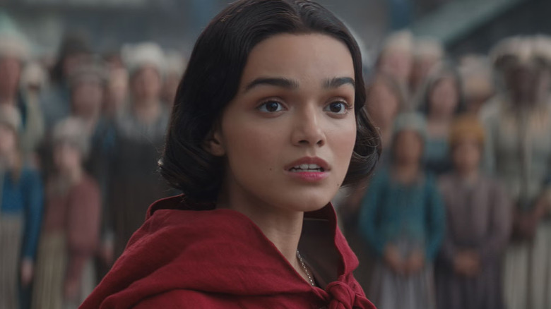 Snow White looking shocked wearing a red cape in Snow White