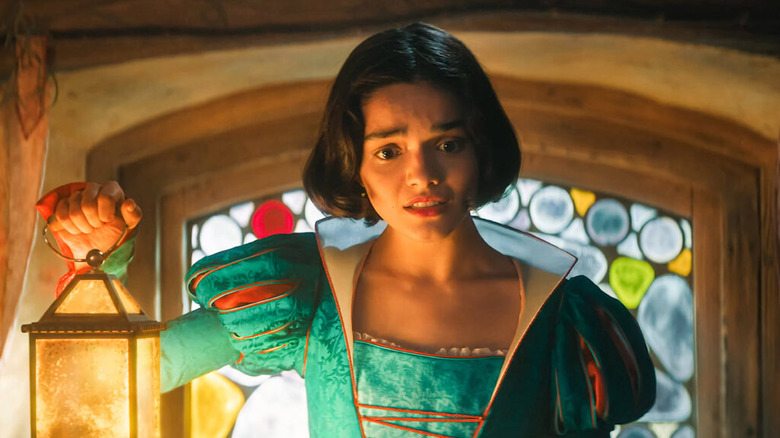 Snow White holding a lantern and looking concerned in Snow White