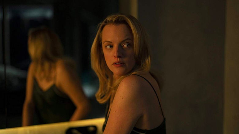 Elizabeth Moss holding a knife