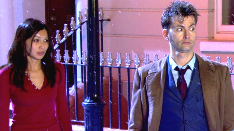 Mia and the Doctor standing under snowfall