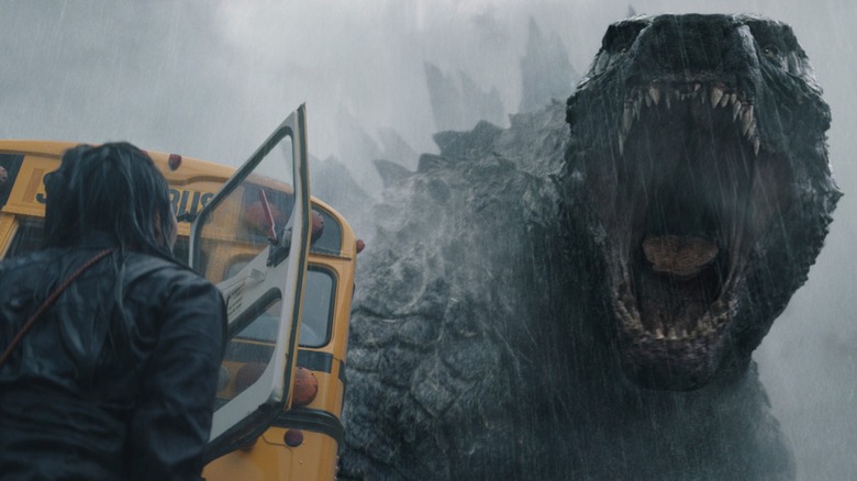 Godzilla roaring next to bus