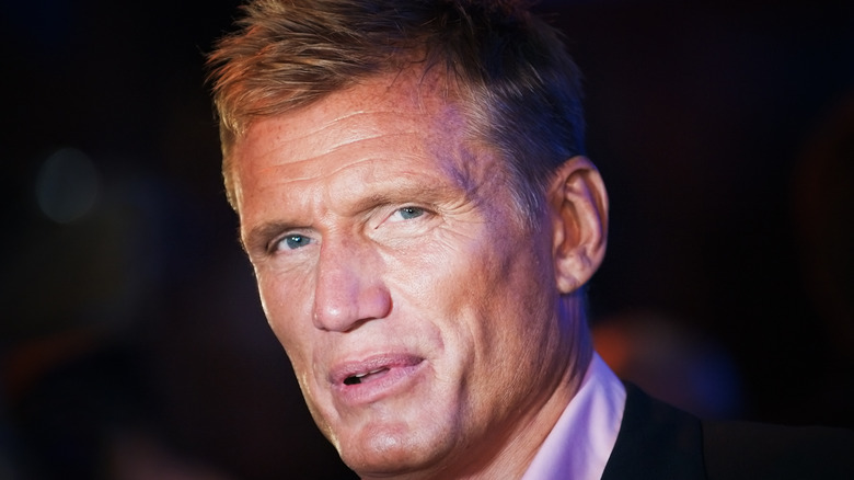 Dolph Lundgren wears purple shirt