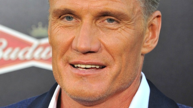 Dolph Lundgren wearing suit and smiling