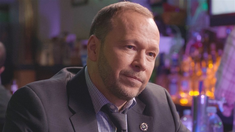 Danny Reagan sitting at bar