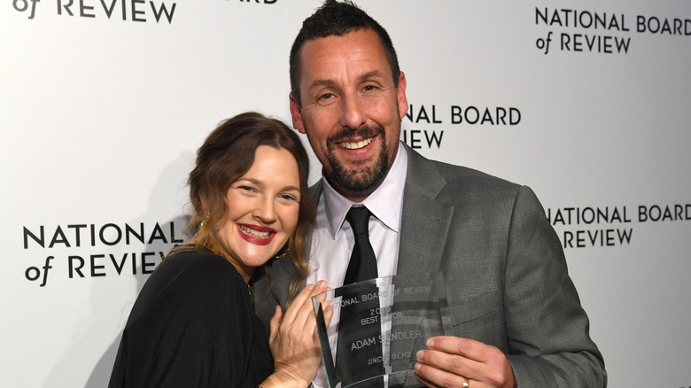 Drew Barrymore and Adam Sandler smiling for a photo