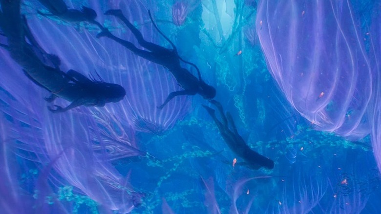 Four Na'vi swim underwater