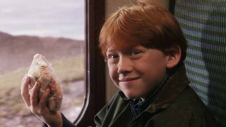 Ron Weasley holding up his homemade sandwiches on the Hogwarts Express