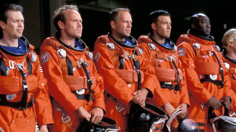Rockhound, Chick, Harry, A.J., and Bear standing in a line holding helmets