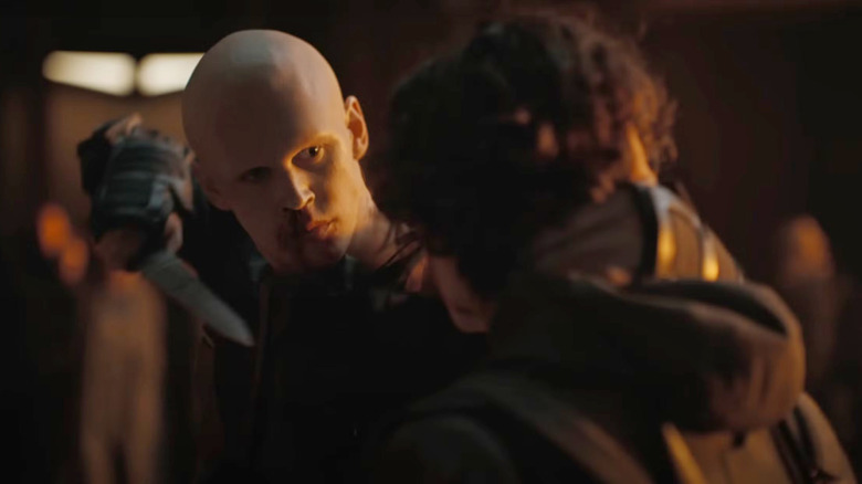 Feyd-Rautha raises his knife as he and Paul square off in 