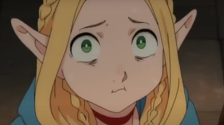Marcille eating something gross and smiling