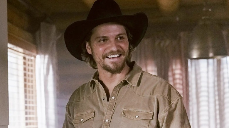 Kayce Dutton wearing a cowboy hat and smiling in "Marshals"