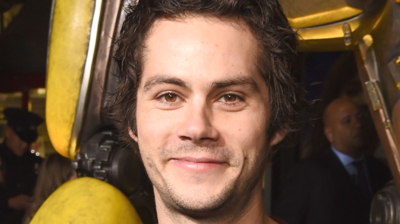 Dylan O'Brien in front of Bumblebee