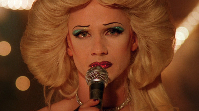 Hedwig holds a microphone in "Hedwig and the Angry Inch" (2001)