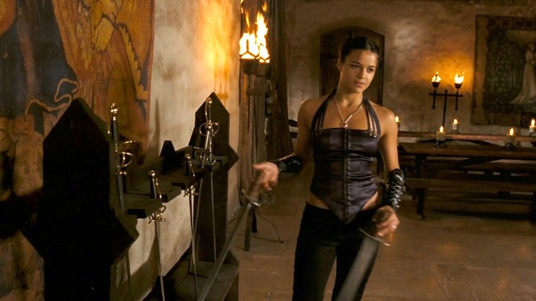   Katharine (Michelle Rodríguez) agafa una espasa