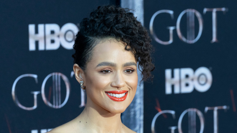 Nathalie Emmanuel smiles and wears her hair up