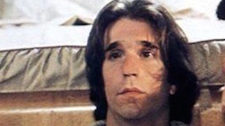 Henry Winkler rests against a bed