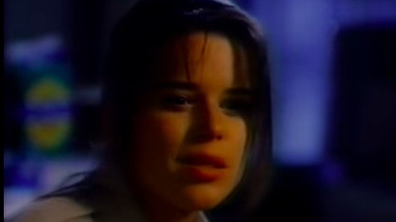 Neve Campbell looks down