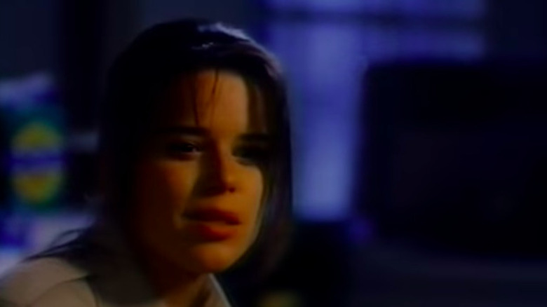 Neve Campbell looks down