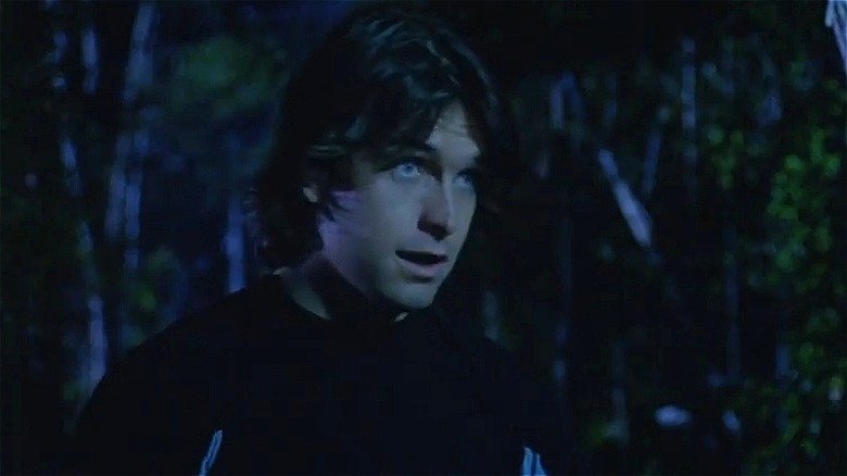 Jason looking nervous in the woods in Terror Peak