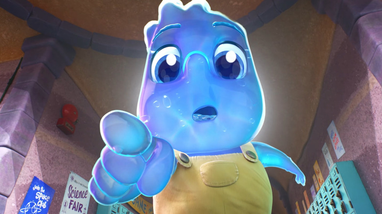 child Wade touches a sponge in school (a sign in the background says "Join the Space Club")