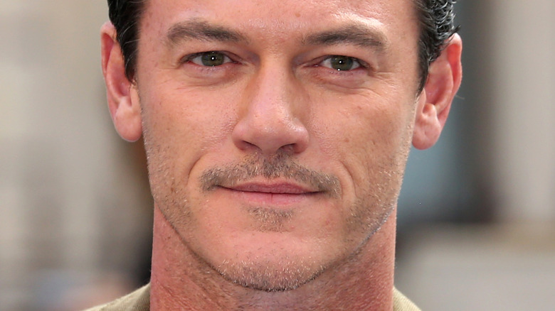 Luke Evans at event smiling