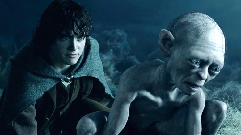 Frodo squats behind Gollum