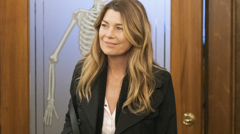 Meredith Grey standing in front of door