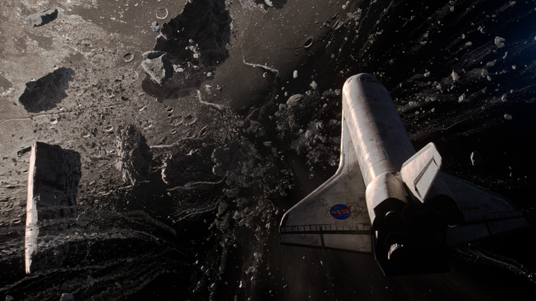 Space shuttle flying through debris