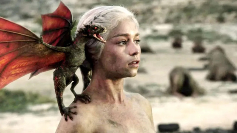 Daenerys with a baby dragon on her shoulder on Game of Thrones