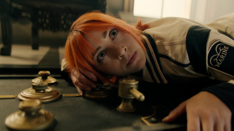 Nami holding ear to safe