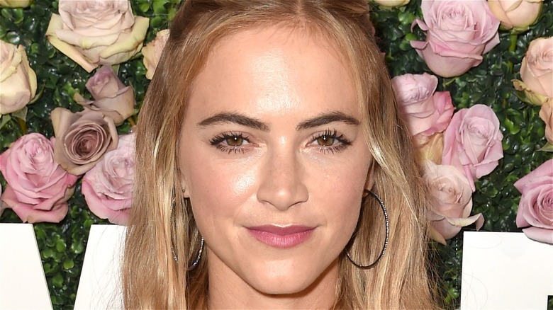 Emily Wickersham against floral backdrop