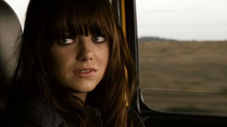 Stone with bangs and heavy eye makeup in car
