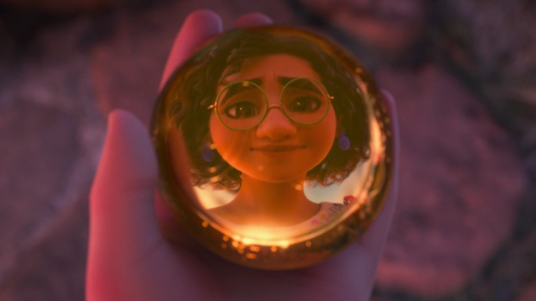 Mirabel's reflection in a doorknob