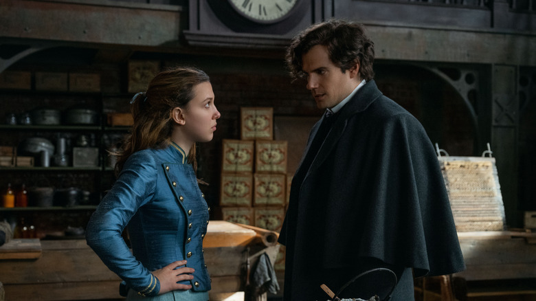 Enola and Sherlock Holmes facing each other in Enola Holmes