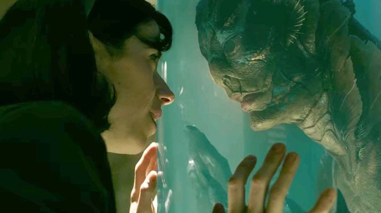 The cleaner looks at creature in The Shape of Water