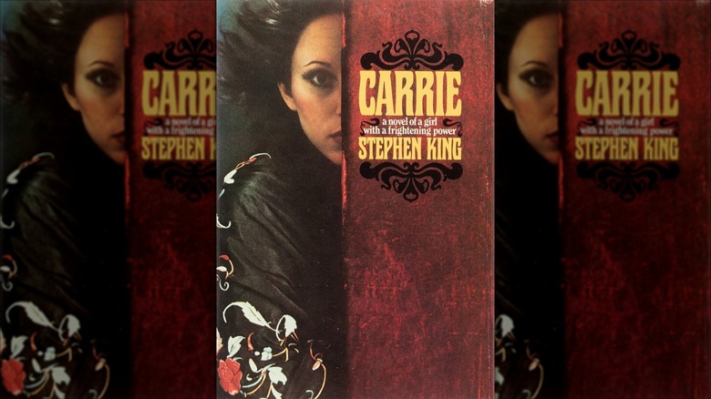 A girl looks out from behind a wall on the cover for the first edition of "Carrie" (1974)