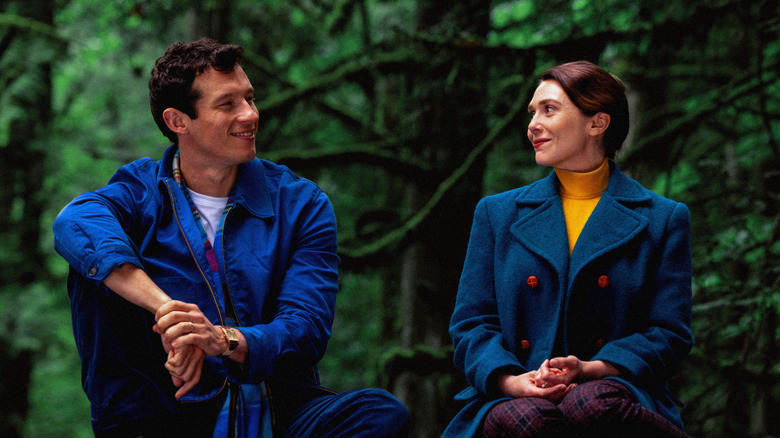 Joan and Luke sitting outside smiling at each other