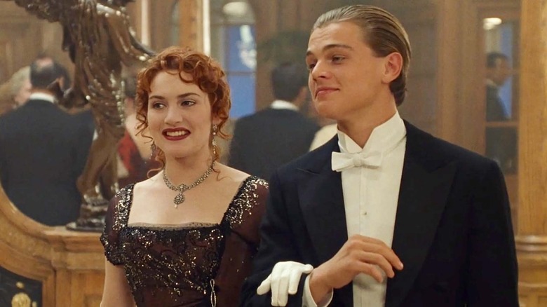 Jack and Rose walk arm in arm in "Titanic" (1997)