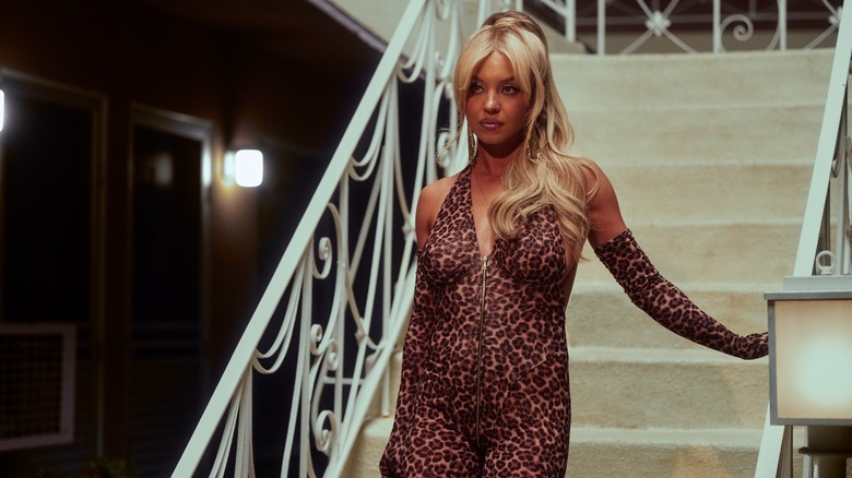Cassie walking down the stairs in a leopard catsuit on Euphoria