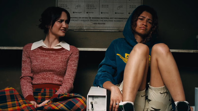 Lexi looking at Rue while they sit on laundry machines in Euphoria Season 3