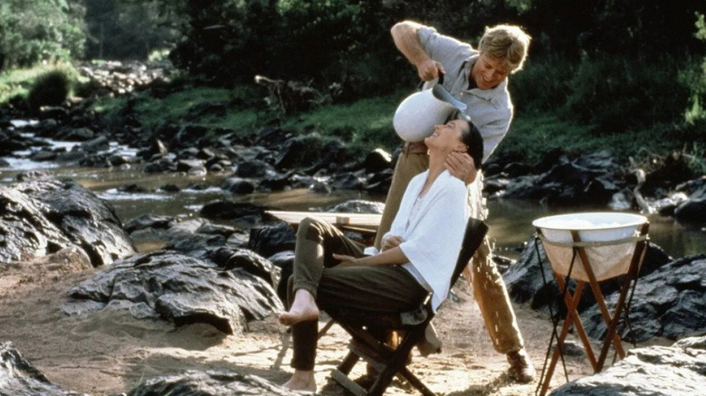Denys Finch Hatton pours water over Karen Blixen in "Out of Africa" (1985)