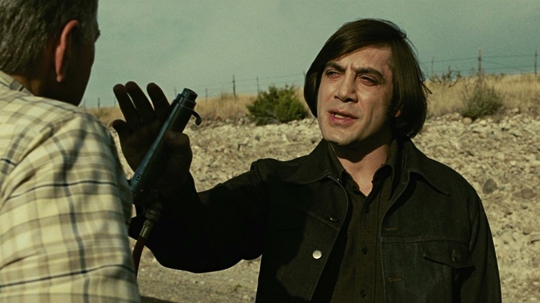 Anton Chigurh talking to a man in "No Country for Old Men" (2007)