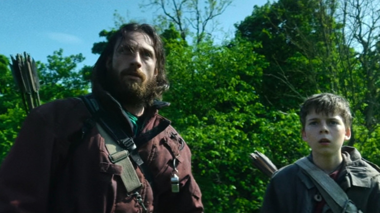 Jamie and Spike looking an infected in the distance in 28 Years Later