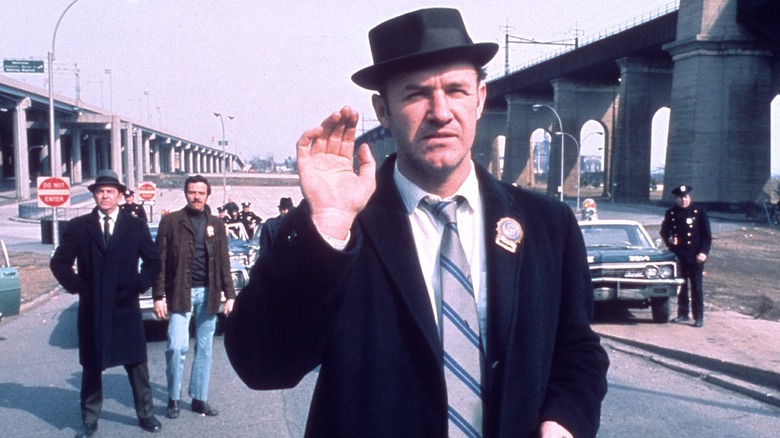 Detective Jimmy "Popeye" Doyle standing in the street in "The French Connection"