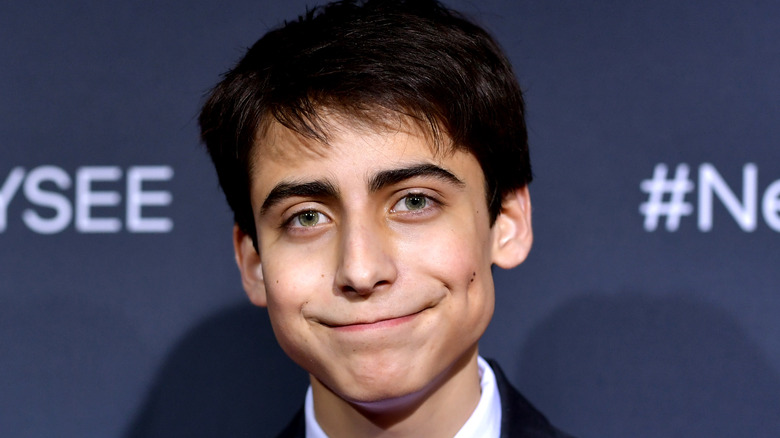 Aidan Gallagher smiling wearing suit